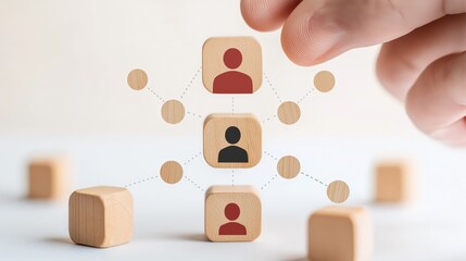 A hand arranging wooden blocks with user icons, symbolizing team structure and networking concepts in a digital environment.