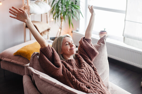 Happy middle aged Woman relaxing at home
