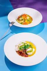 Two exquisite dishes served on white plates, a culinary delight
