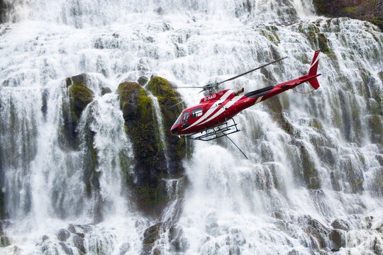 Airbus Helicopter H125 flying near a Dynjandi waterfall in the Westfjords region of Iceland
