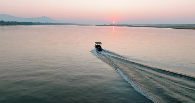 Aerial view. Tourist boat sightseeing on the Zambezi river at sunset