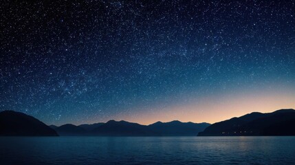 Night sky reflecting in calm water with mountains on horizon