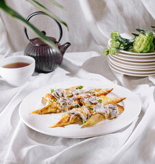 Savory stuffed crepes with mushrooms and creamy sauce on white plate