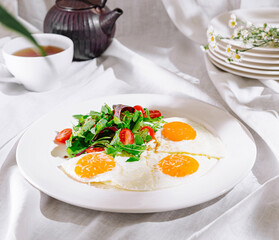 Sunny side up eggs with salad for healthy breakfast at home
