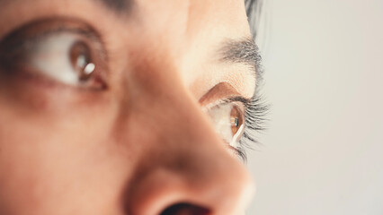 A closeup portrait of a young woman looking away from the camera