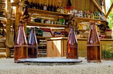 bottles of beer on a table in a corner store..
