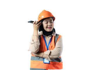 Young Asian female construction worker in hijab who looks very angry while on a voice call, industrial and construction concept, isolated white background.