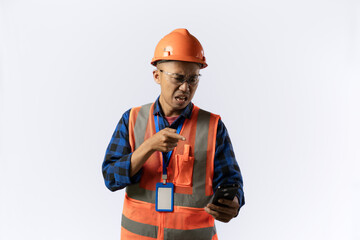 Asian adult male construction worker who looks very angry while on a video call while carrying a clipboard report, industrial and construction concept, isolated white background.