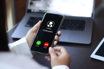 Unknown number displayed showing on smart mobile phone. Human use smartphone with incoming call...