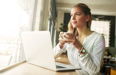 Cafe, woman thinking and coffee with laptop for research, ideas and editing information for business story. Freelancer, editor and espresso in restaurant for drinking, tea or digital for news article