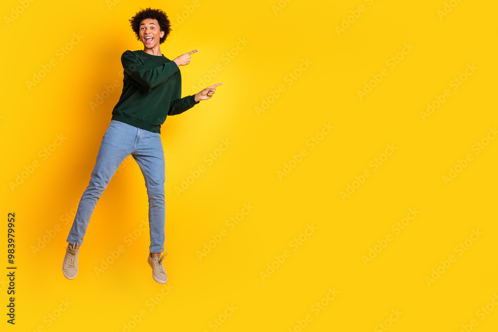 Sticker Full size photo of nice young man jump direct empty space wear pullover isolated on yellow color background