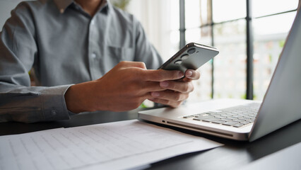 Business man hold smartphone in modern office executive technology