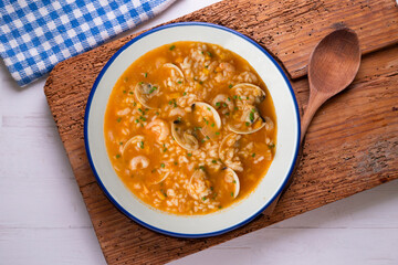 Rice soup with shrimp and clams. Top view table with  decoration.