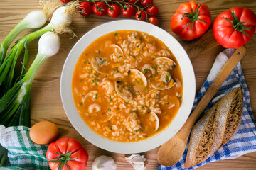 Rice soup with shrimp and clams. Top view table with  decoration.