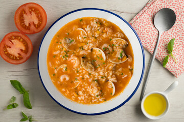 Rice soup with shrimp and clams. Top view table with  decoration.