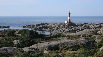 Cast iron Eiger&oslash;y lighthouse, rock formations and sea, Norway.