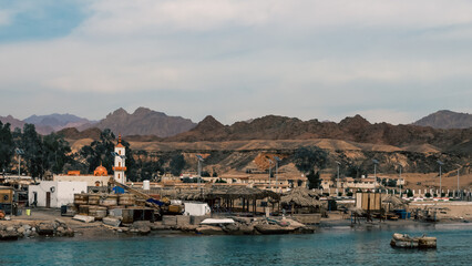 Fototapeta premium fishing village on the coast of the Red Sea against the backdrop of the mountains of Egypt