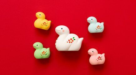 Japanese new year material. Zodiac Snake. Snakes ornament on the red background. 日本のお正月素材。干支の巳（ヘビ）。赤背景上の巳の置物