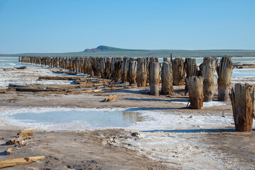 Rows of wooden pillars in Baskunchak salt lake, Astrakhan region, Russia