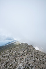 Mountain landscapes covered with white clouds. Cloudy mountains. Blue sky and magnificent white clouds. Magnificent Uludağ treking routes. Cloudy views from Uludağ.