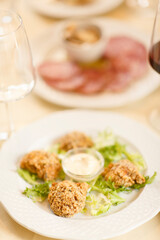 Close up on italian traditional northern food on a restaurant table. Many dishes are visible.