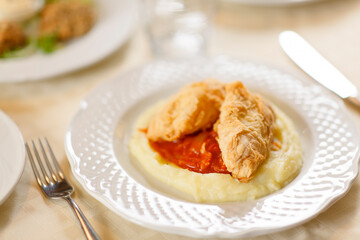 Close up on italian traditional northern food on a restaurant table. Many dishes are visible.