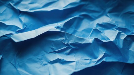Obraz premium Close-up of a blue sheet of paper with creases and folds visible, providing a textured background or template for various design uses