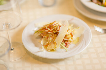 Close up on italian traditional northern food on a restaurant table. Many dishes are visible.