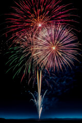 colorful red white and blue fireworks in the night sky.