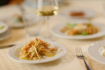 Close up on italian traditional northern food on a restaurant table. Many dishes are visible.