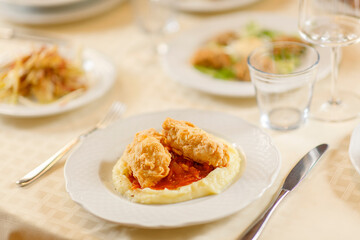 Close up on italian traditional northern food on a restaurant table. Many dishes are visible.