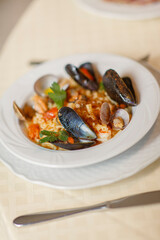 Close up on italian traditional northern food on a restaurant table. Seafood pasta recipe.