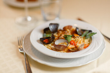 Close up on italian traditional northern food on a restaurant table. Seafood pasta recipe.