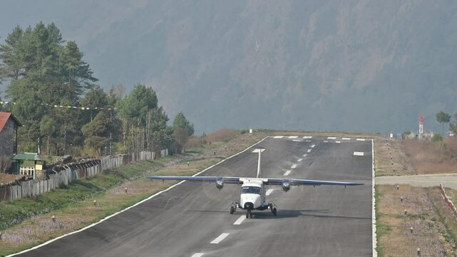 A propeller plane while landing on Lukla airport the most dangerous airport in the world in Nepal. These airlines making it a popular choice among trekkers and adventurers heading to the Everest.