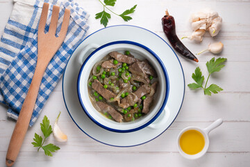Strips of beef cooked with onion and peas. Top view table with  decoration.