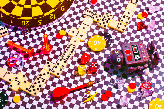 Assorted colorful gaming pieces on a checkered background