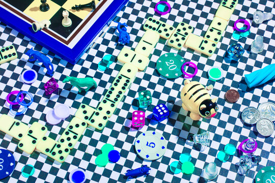 Colorful montage of various game pieces and coins