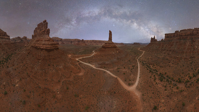 Panoramic view of Milky Way over a rugged desert landscape in Valley of Gods, Utah - Powered by Adobe