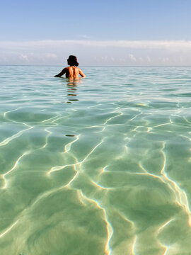 Woman enjoying snorkeling in clear Caribbean waters
