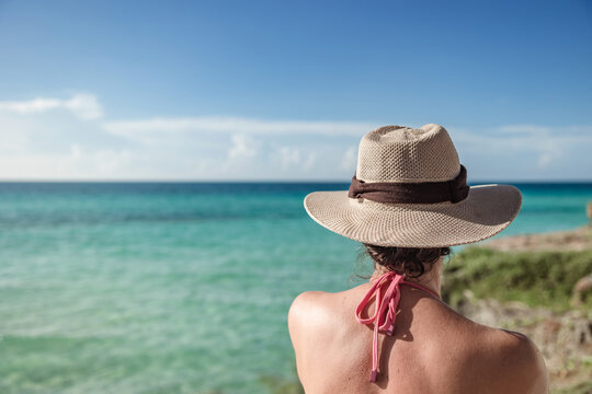 Back view of unrecognizable woman enjoying Varadero Beach