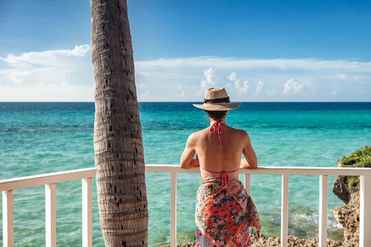 Woman enjoys serene Caribbean beach view in Varadero, Cuba