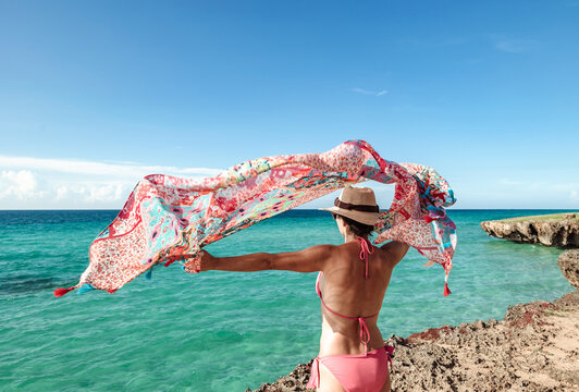 Back view of unrecognizable woman enjoying Varadero Beach