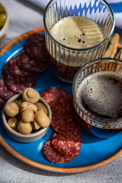 Traditional kvass served with fried fish, sausages, and mushroom