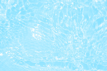 Blue water with ripples on the surface. Defocus blurred transparent blue colored clear calm water surface texture with splashes and bubbles. Water waves with shining pattern texture background.