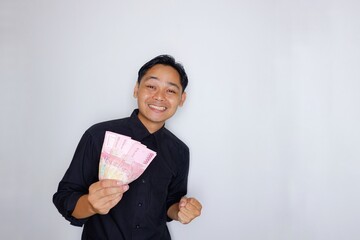 Random expression of adult Asian Indonesian man while holding banknotes isolated on white background