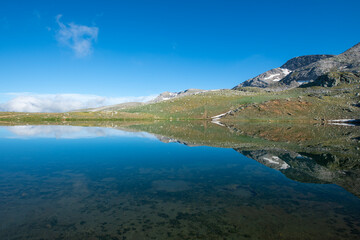 Reflection of clouds in the blue sky in the lake.Reflections in the glacial lake. Reflections on Kilimli lake. Lakes on top of Uludağ, Kilimli Lake, Bursa, Türkiye.