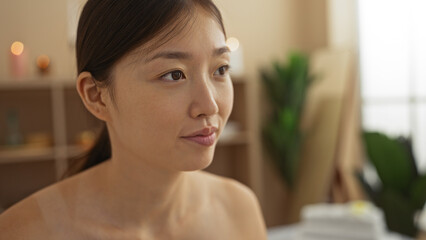 Young, attractive, chinese woman in a spa beauty center with soft lighting and wellness ambiance