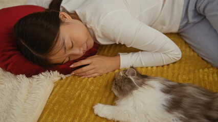 A young chinese woman lies on a bed in her bedroom, sharing a quiet moment with her cat, creating a cozy and intimate indoor scene at home.