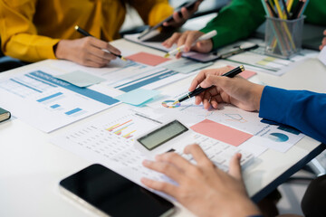 Business corporate team brainstorming, planning strategy having a discussion Analysis investment researching with chart at office desk documents in office.