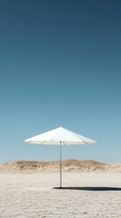 A white umbrella is standing in the middle of a desert